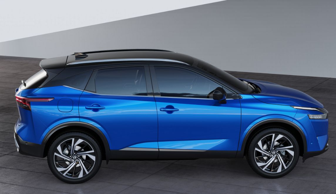 Side profile of a blue Nissan Qashqai in a manufacturer studio