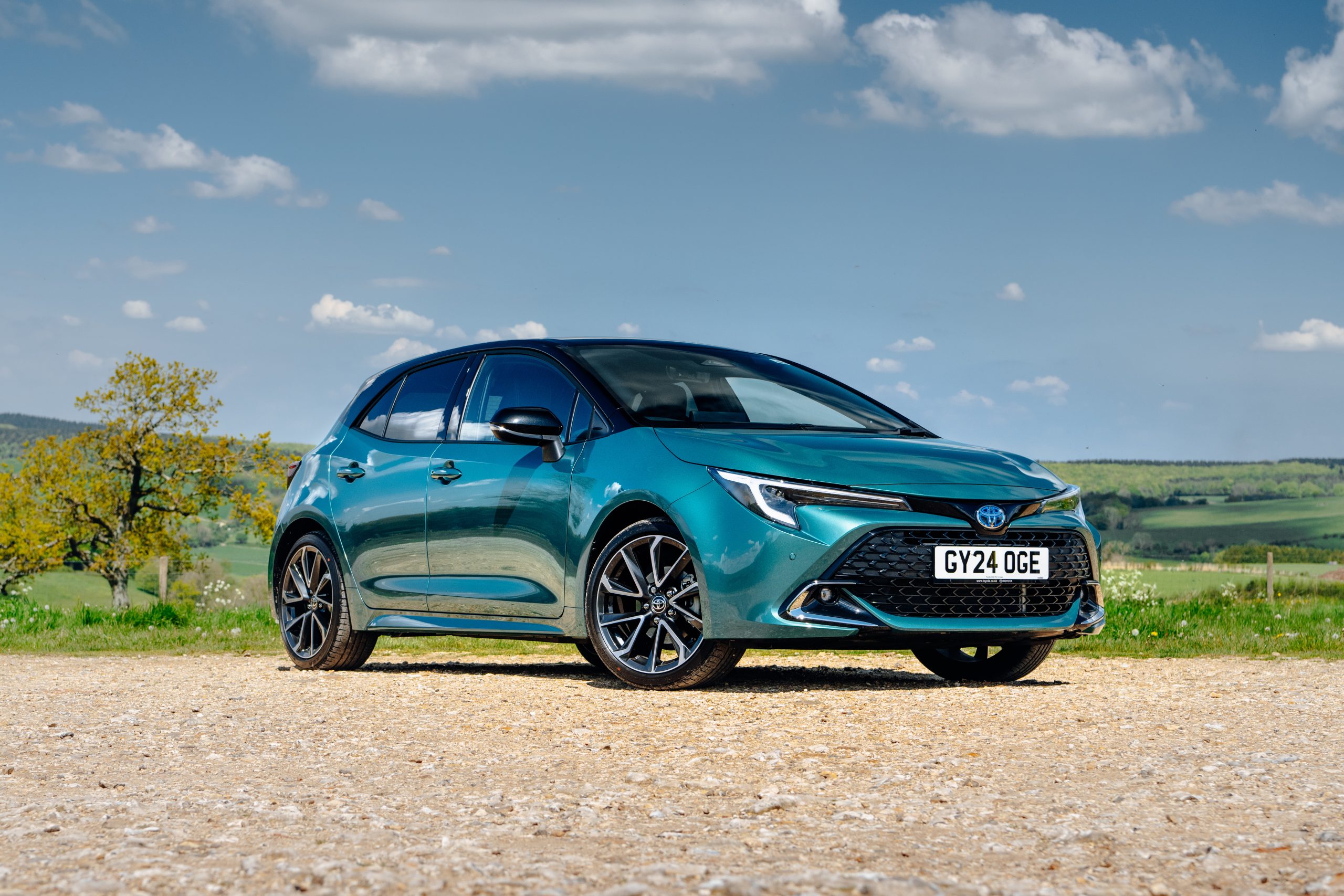Green Toyota Corolla photographed in the countryside