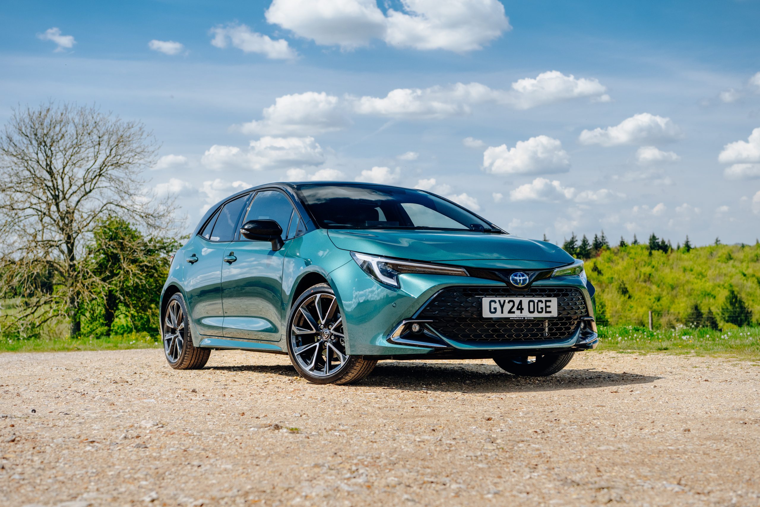 Green Toyota Corolla in an official countryside press photograph