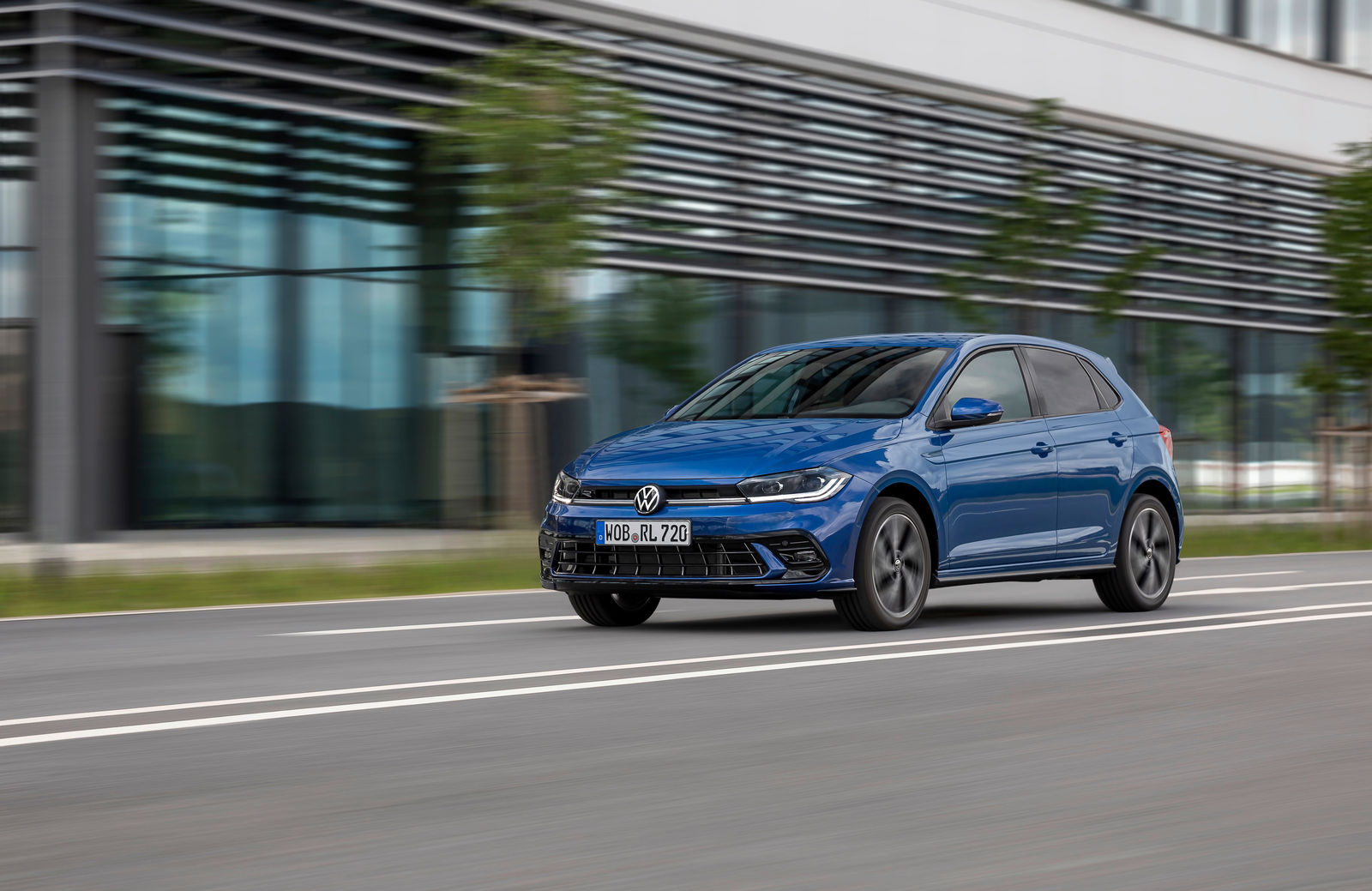 Blue Volkswagen Polo driving on an urban road